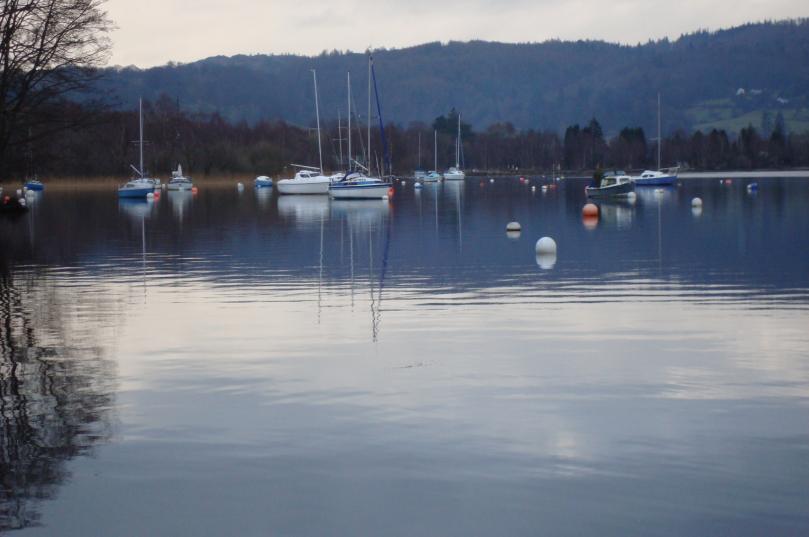 A tranquil picture of yachts quietly floating on Coniston water.